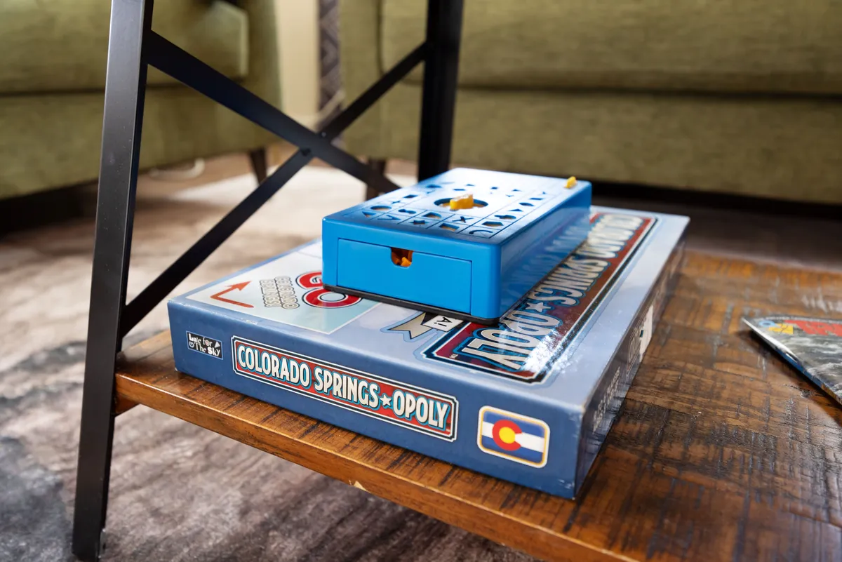 A cozy scene with a board game and game box on a coffee table, set in a comfortable living area. The image radiates an atmosphere of playful interaction and shared experiences.